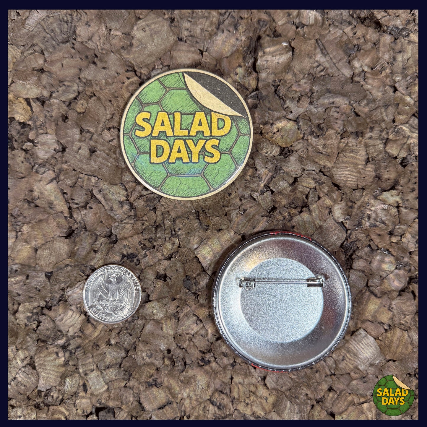 Two buttons on a textured surface, one labeled 'Salad Days' with a coin for scale showing the 2.25" button size.